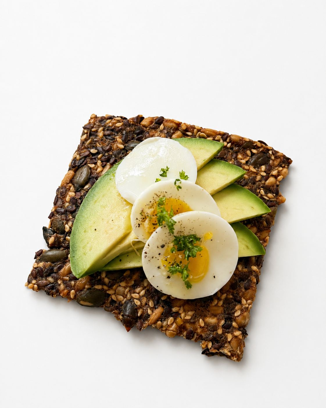Cracker with avocado and egg