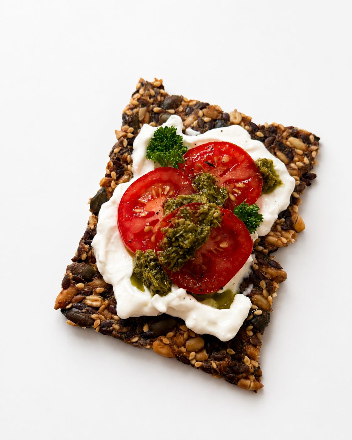Cracker with cream cheese tomato pesto